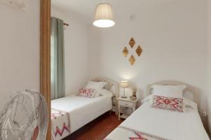 a bedroom with two beds and a mirror at La Casa Amarilla in El Paso