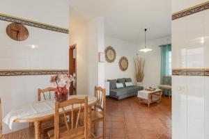 a kitchen and living room with a table and a couch at La Casa Amarilla in El Paso