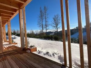 a porch of a cabin in the snow at Ferienwohnung am Stadtwald in Triberg