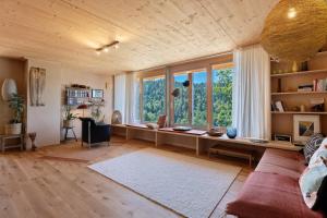 a living room with a couch and a large window at Ferienwohnung am Stadtwald in Triberg