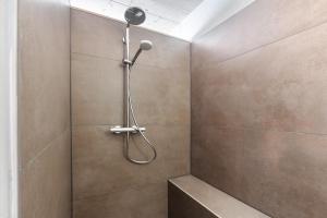 a shower with a shower head on a wall at Ferienwohnung am Stadtwald in Triberg +25 photos