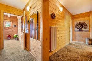 a hallway in a log home with wooden walls at Agritur El Casel in Brentonico +61 photos