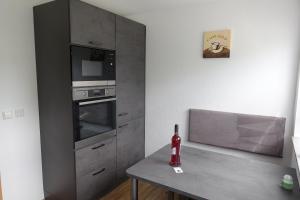 a kitchen with a table with a bottle of wine at Ferienwohnung Mai, 63qm in Plettenberg
