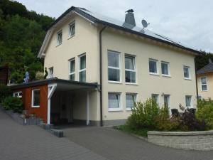 a large white house with a driveway at Ferienwohnung Mai, 63qm in Plettenberg