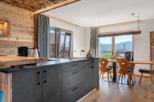 a kitchen with a counter and a table with chairs at Moarhof in Meltina