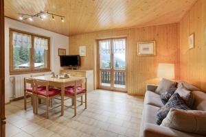 a living room with a couch and a table at Chalet Holly in Bormio