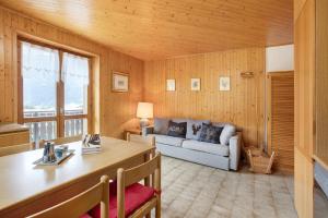 a living room with a couch and a table at Chalet Holly in Bormio