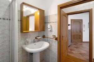 a bathroom with a sink and a mirror at Residence Malibu Appartamento 8 in Falcade +17 photos