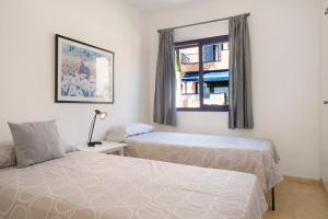 a bedroom with two beds and a window at Free Airport Shuttle and Parking in San Bartolomé +18 photos