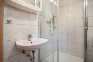 a bathroom with a sink and a shower at Bungalow Arkona Bgl 1 in Dranske +17 photos
