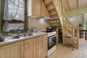 a kitchen with a sink and a stove at Villa Fotini Lefkada in Lefkada