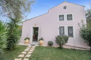 a white house with plants in front of it at Villa Fotini Lefkada in Lefkada