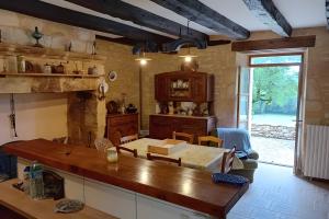 a kitchen with a table and a dining room at La Maison De Carmensac in Meyrals