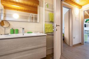 a bathroom with a sink and a mirror at Agriturismo Bocca Nevese Pino in Tremosine Sul Garda +27 photos