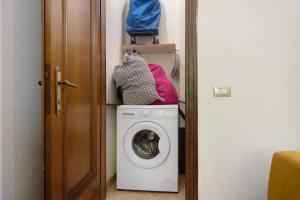 a washing machine with a pink pillow on top of it at Levanto A 50 Metri dal Mare in Levanto