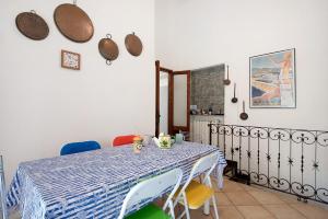 a dining room with a blue and white table and chairs at Levanto A 50 Metri dal Mare in Levanto