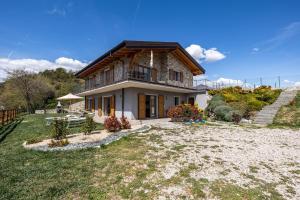 a house with a large yard in front of it at Agriturismo Bocca Nevese Pino in Tremosine Sul Garda