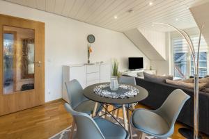 a living room with a table and chairs and a couch at am Salinensee in Bad Dürrheim