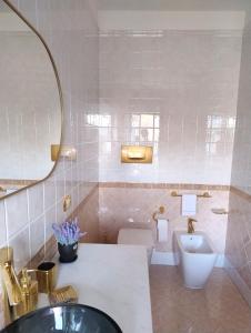 a bathroom with a sink and a toilet at Royal Residence Abano Terme in Abano Terme +37 photos