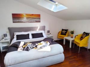 a bedroom with a large bed and two yellow chairs at Royal Residence Abano Terme in Abano Terme