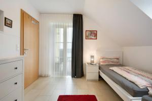 a bedroom with a bed and a window at Appartement Rosi in Ihrlerstein
