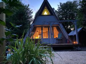 a small house with a large window in a yard at Ferienhaus am Waldrand in Billerbeck +3 photos