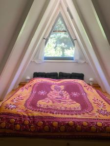 a large bed in a room with a window at Ferienhaus am Waldrand in Billerbeck