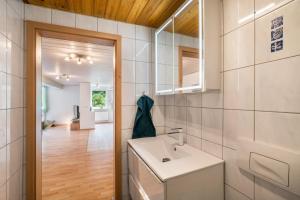 a bathroom with a sink and a mirror at Ferienwohnung Waldblick in Freudenstadt +17 photos