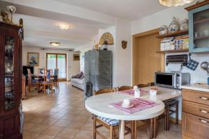 a kitchen and living room with a table and chairs at Villa Fiore in Lamon