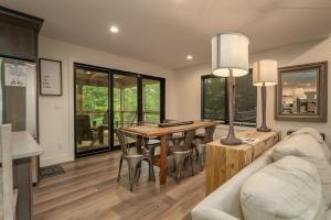 a living room with a table and a couch at Hemlock Cottage · Hemlock Cottage in Pisgah Forest - Pet Friendl in Brevard