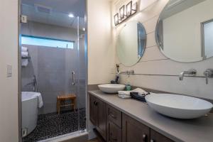 a bathroom with two sinks and a shower at Hemlock Cottage · Hemlock Cottage in Pisgah Forest - Pet Friendl in Brevard +15 photos
