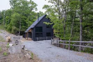 a black house with a sign in front of it at Hemlock Cottage · Hemlock Cottage in Pisgah Forest - Pet Friendl in Brevard
