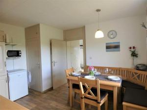 a kitchen and dining room with a table and chairs at Fewo Siglinde Schneider in Freiamt
