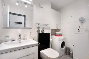 a white bathroom with a sink and a washing machine at Ferienwohnung Wölk in Sonthofen +14 photos