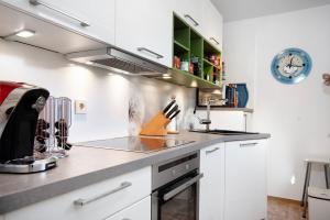 a kitchen with white cabinets and a counter top at Ferienwohnung Wölk in Sonthofen