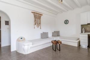a white living room with a couch and a table at Ow Andros Suite 5,Private Whirlpool in Andros