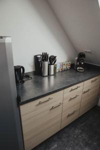 a kitchen with a counter top with wooden cabinets at Ferienwohnung Wunderbar in Bad Wildbad