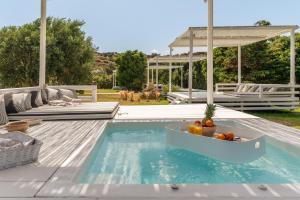 a pool with a bowl of fruit in a boat in the water at Ow Andros Suite 5,Private Whirlpool in Andros