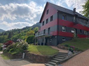 a house with a red and gray building on a hill at Ferienwohnung Wunderbar in Bad Wildbad