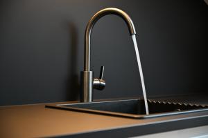 a kitchen sink with a faucet on a counter at Ferienwohnung Nordschwarzwald in Altensteig +18 photos
