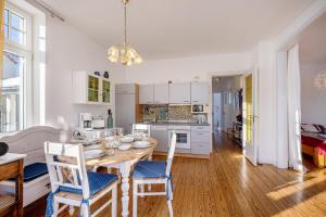 a kitchen and dining room with a table and chairs at Haus Übersee Wohnung Fidji in Travemünde