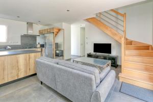 a living room with a couch and a kitchen at Villa Ker Minet - Houat - 8 pers in Piriac-sur-Mer