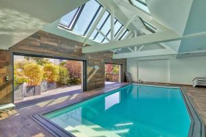an indoor swimming pool in a house with a skylight at Villa Ker Minet - Houat - 8 pers in Piriac-sur-Mer