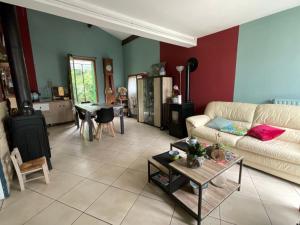 a living room with a couch and a table at Maison de vacances Pradines in Pradines