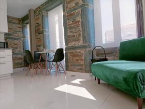 a bedroom with a bed and a table and chairs at Valley Apartamentos T1 in Vila Nova de Foz Coa +3 photos
