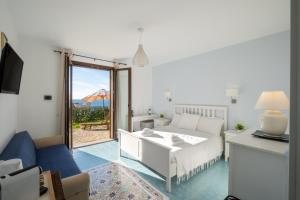 a living room with a white couch and a table at Cala D'Aspide in Santa Caterina di Nardò