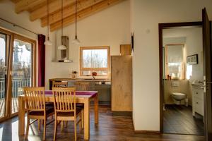 a kitchen and dining room with a table and chairs at Ferienwohnung Lindenhof in Dormettingen