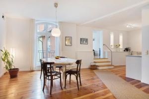 a kitchen and dining room with a table and chairs at Alte Seifensiederei 2 in Stralsund