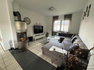 a living room with a couch and a fireplace at Ferienhaus Almir in Haselünne