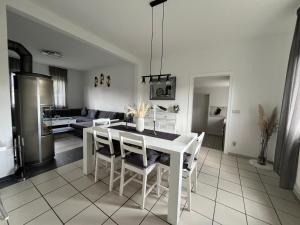 a kitchen and living room with a white table and chairs at Ferienhaus Almir in Haselünne